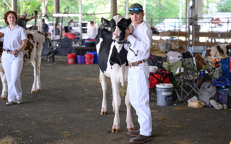Nathaniel Doss stands with his dairy cow named Magnolia. ZACH TAYLOR/Special
