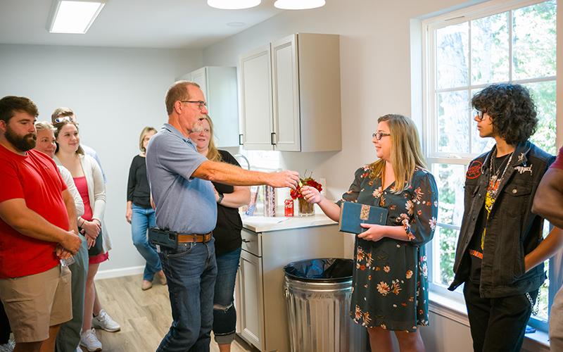 Habitat for Humanity Board President Rex Wade hands the house keys to Alicia Murphy in the second Habitat For Humanity home dedication on Sunday. ZACH TAYLOR/Special