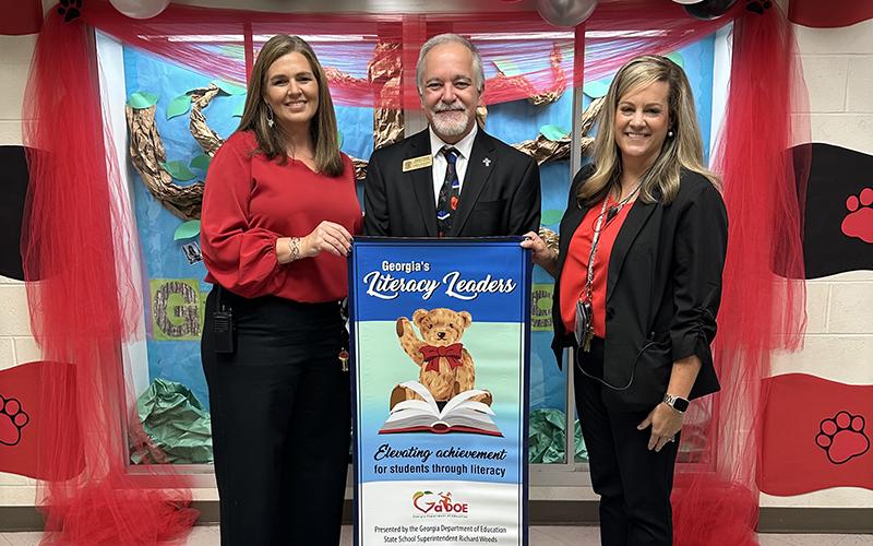Level Grove Elementary School Principal Aimee Shedd (left), Georgia School Superintendent Richard Woods (center), and Level Grove Assistant Principal Stefanie Eaton (right), celebrate the school’s recognition as a “Literacy Leader.” SUBMITTED