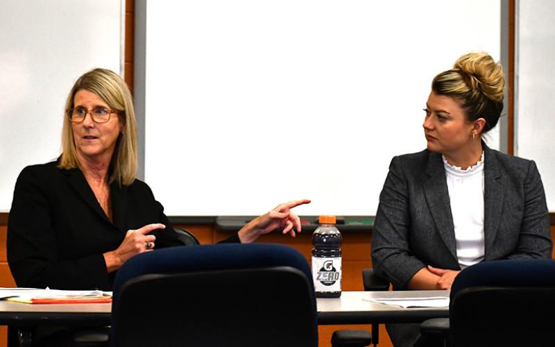 Suzanne Boykin, left, and Rebecca James, right, teach students on the Habersham County Mock Trial team legal practices they can use at competition. JULIANNE AKERS/Staff