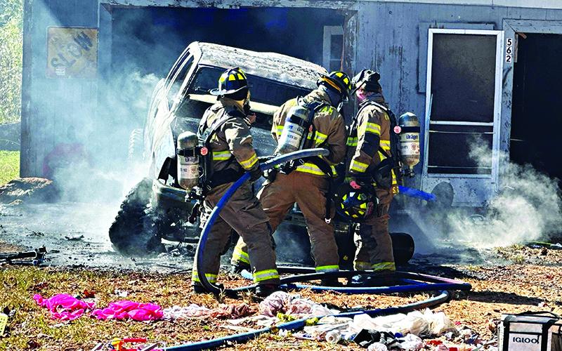 Habersham County firefighters check the engine compartment of the burning truck on Sutton Road in the Fairview community. HABERSHAM COUNTY/Submitted