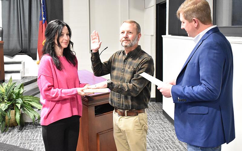 Demorest Councilman Donnie Bennett is sworn in by Mayor Jerry Harkness for a new term Tuesday night along with his wife Nikki. MATTHEW OSBORNE/Staff