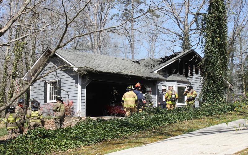 Firefighters inspect a home on Modoc Street in Cornelia after a fire Tuesday. BRIAN WELLMEIER/Special