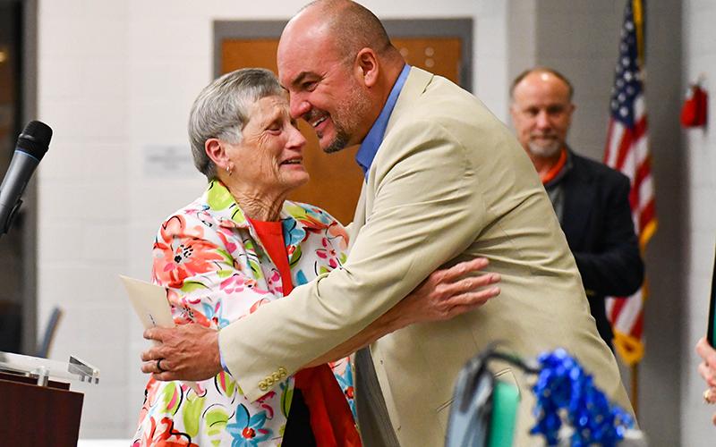 Linda Garrett goes in for a hug with Superintendent Matthew Cooper after being named support person of the year. JULIANNE AKERS/Staff