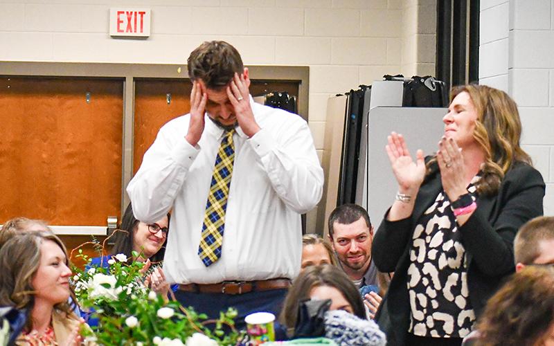 Daniel Medders stands in astonishment after finding out he is named Habersham County teacher of the year. Level Grove Principal Aimee Shedd (right) stands to cheer him on. JULIANNE AKERS/Staff 