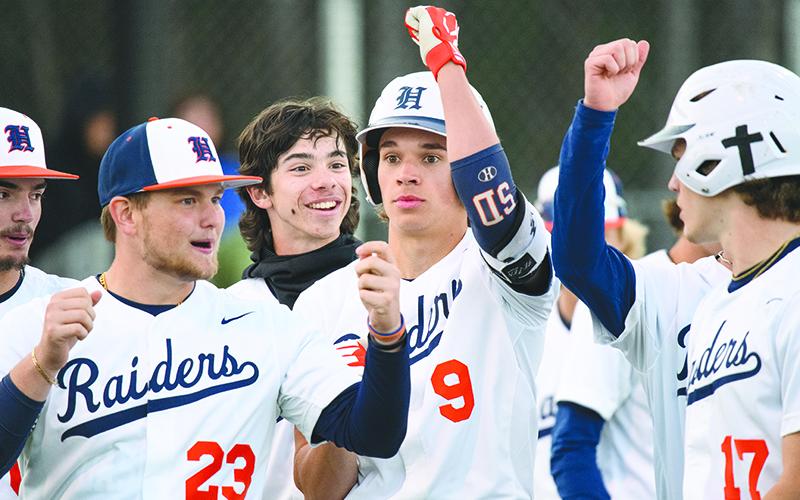 The Raiders celebrate with  Konnor Burrell after he hit a  two-run home run in the bottom of the 5th  inning against Apalachee last week. ZACH TAYLOR/ Special