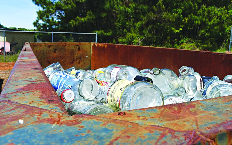 Glass bottles sit at the Cornelia Recycling Center waiting to be hauled and processed. JULIANNE AKERS/Staff