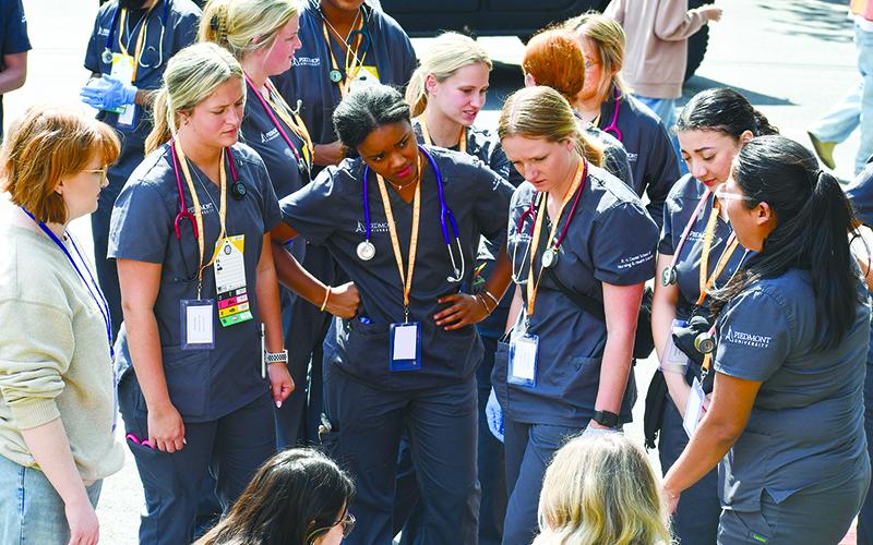 Piedmont nursing students analyze the staged mass casualty situation. JULIANNE AKERS/Staff