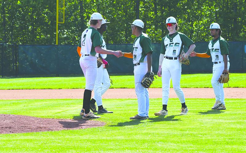 Tallulah Falls’ Gregory Mendez, Andrew Skvarka and Diego Gonzalez hype up pitcher Chase Pollock before the start of an inning against Oglethorpe in the first round of the playoffs. LANG STOREY/Staff
