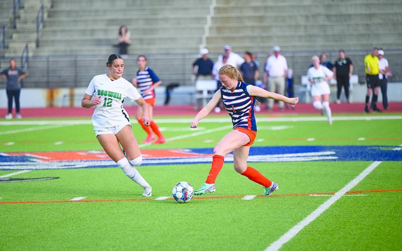 Habersham Central’s Annabelle Clark dribbles around the Roswell midfielder in the Sweet 16 game Thursday night. ZACH TAYLOR/Special 