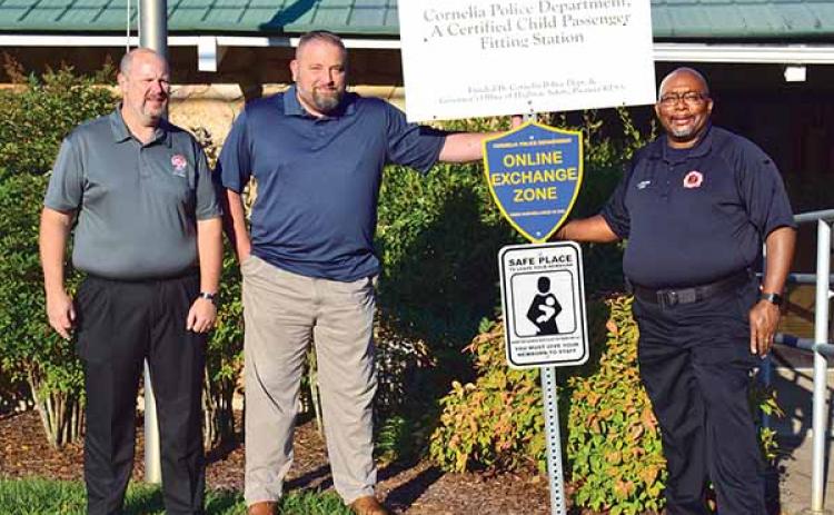 Shown with one of the new “safe haven” signs, located at the Cornelia Police Department, is, from left, City Manager Donald Anderson, Police Chief Chad Smith and Fire Chief Billy Jenkins Jr. (Photo/CHRISTINA SANTEE)