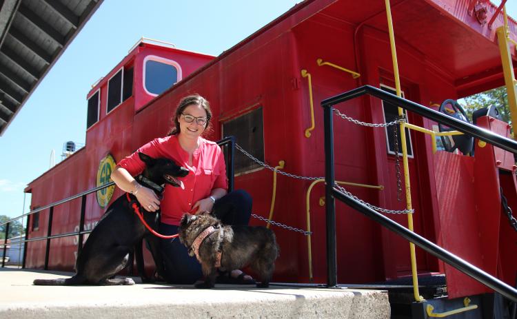 Eric Pereira/ Cornelia Tourism Coordinator Brittain Williams and her dogs Cerin and Tara are shown at the Cornelia Depot. Visitors are allowed to bring their dogs into the Cornelia Historic Train Depot and Museum.