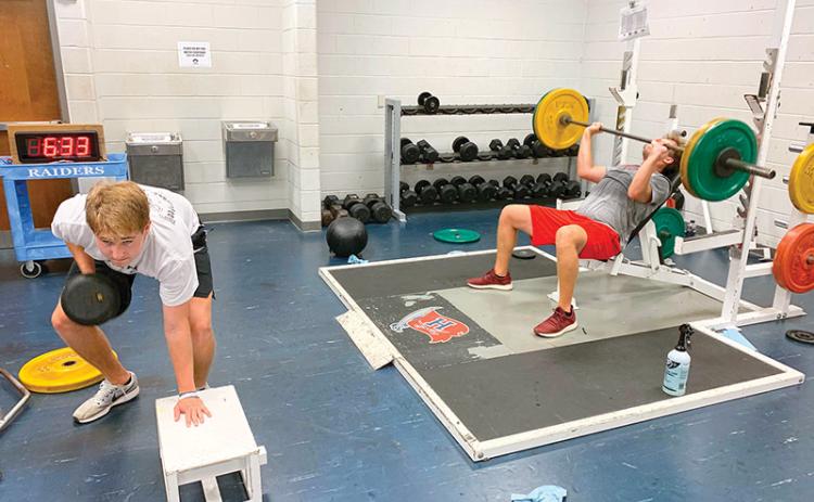 Habersham Central’s Grant Tipton (left) and Gabe Hudlow run through weight training and drills earlier this week after returning to campus for the first time since the COVID-19 shutdown.
