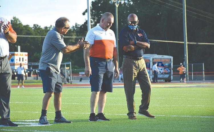 Habersham Central Ring of Honor inductee Jerry Pulliam (left) talks football with fellow defensive legends and inductees Jeff Gerrin and Fernandez West before Friday’s game. LILLIAN VAN TASSEL/Special