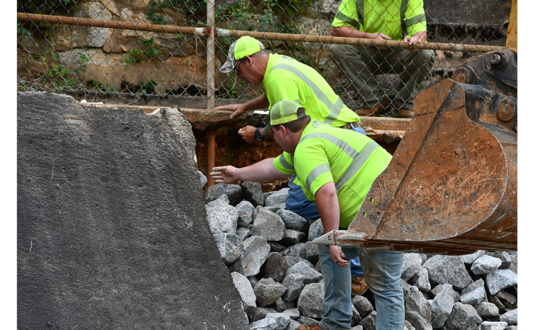 Department of Transportation workers try to place the rocks in the right places as they bolster the retaining wall on Central Avenue in Demorest. The wall is slated to be fixed in 2023 but its condition is worsening. MATTHEW OSBORNE/Staff