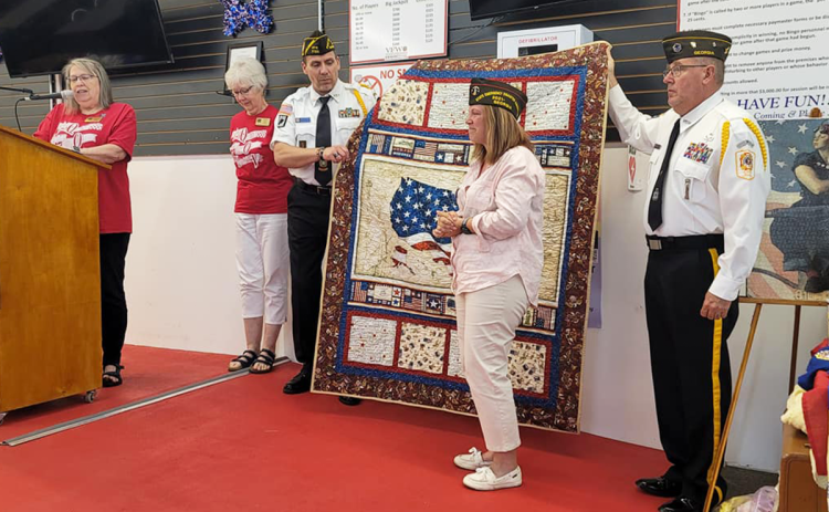Gabrielle Beutler (center) receives a Quilt of Valor at a May luncheon at the VFW Grant-Reeves Post 7720 in Cornelia. FILE