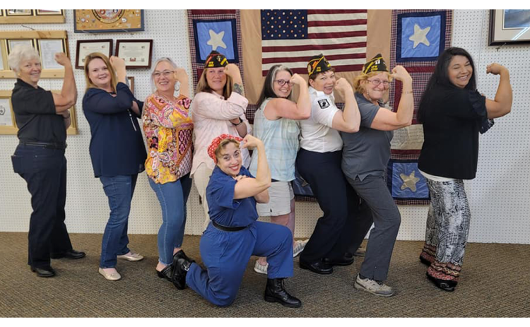 Gabrielle Beutler (fourth from left) posed with actual veterans with a Rosie the Riveter impersonator at a women’s luncheon in Cornelia on May 21.