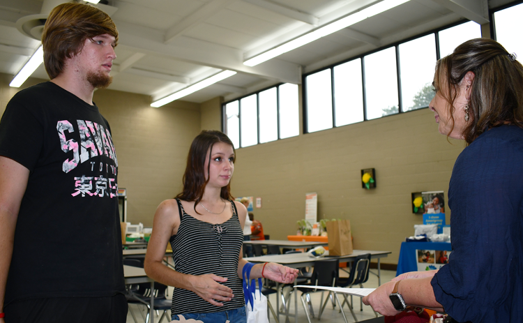 Young parents Connor Smith and Ariel Bennett inquire about resources at Mountain Education Charter School on Tuesday. BRIAN WELLMEIER/Staff