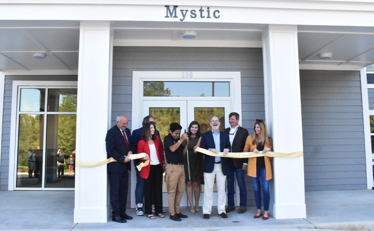 Bruce Willis, Nick Kastner, Kim Crawford, Leonardo Galarza, Madison Smith, James Mellichamp, Jerry Harness, and Mary Beth Horton gathered to celebrate the official opening of Piedmont Universities’ newest residence hall, Mystic Hall, during the special ribbon-cutting celebration on Friday. AMARIS E. RODRIGUEZ/Staff