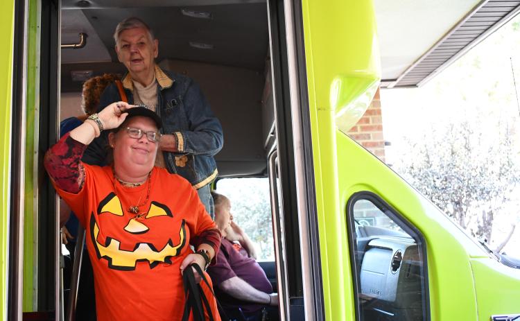 Joy Burrell and Helen Dove get off the Habersham County Senior Center’s new transit bus with a smile. JOHN DILLS/Staff
