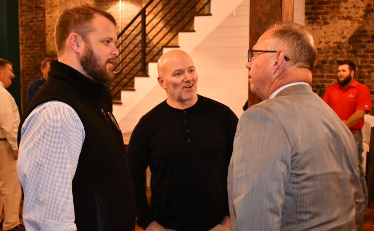 Sen. Bo Hatchett (left) talks with Jeff Wilson and Jim Weidner at his victory party in Cornelia on Tuesday night. MATTHEW OSBORNE/Staff