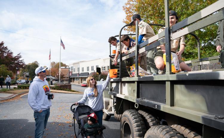 Members of Clarkesville Boy Scouts Troop 5 (right) give candy to the English family (left). ZACH TAYLOR/Special