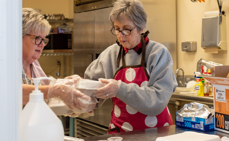 Mary Fournier and Tina Evans help prepare meals at the First Presbyterian Church of Clarkesville on Christmas Day. E. LANE GRESHAM/Special 
