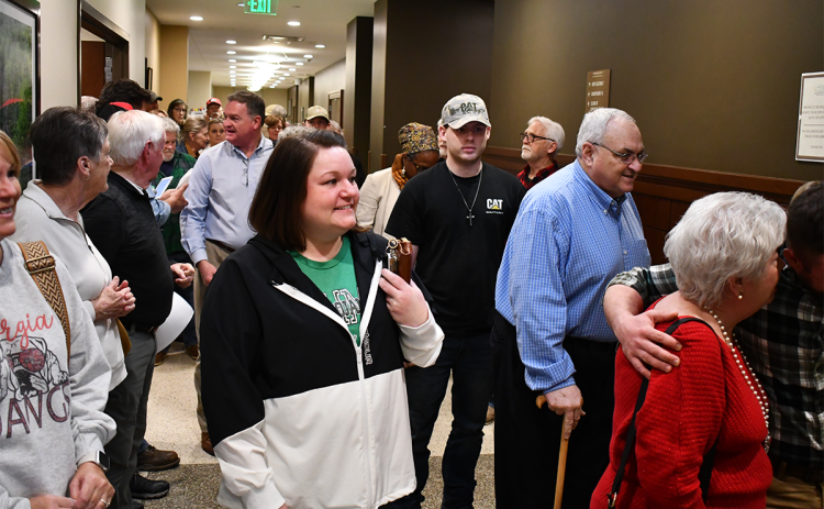 County residents pour into the courthouse Monday night trying to get into the chambers for the Board of Commissioners’ meeting. There was overflow attendance to talk about housing developments and the Total Fitness controversy. MATTHEW OSBORNE/Staff