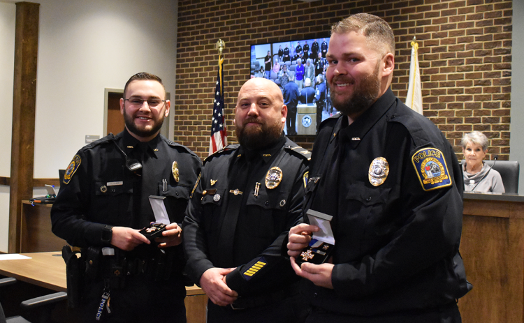 Officers Jonathan Hughes and Joey Newkirk receiving their National Law Enforcement Life Saving Awards from Chief Jonathan Roberts (middle). EMMA MARTI/Staff