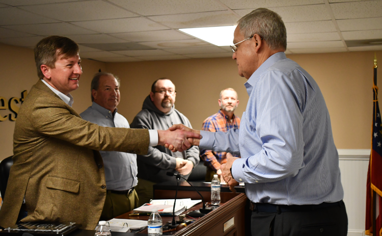 Piedmont President Marshall Criser (right) shakes hands with Demorest Mayor Jerry Harkness on Tuesday night. MATTHEW OSBORNE/Staff