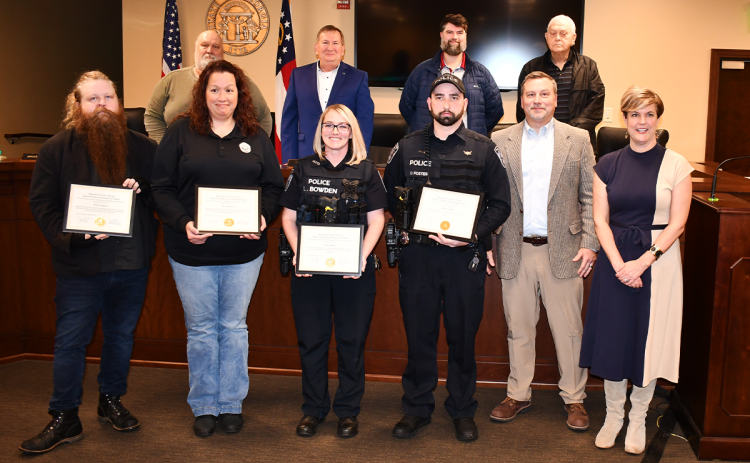 Habersham County honored four public safety heroes Monday night, including (front row from left) Jaron Loggins, Kim Fauscett, and Baldwin Police Officers Leta Bowden and Dakota Foster. Also in front row are Chairman Ty Akins and County Manager Alicia Vaughn. In back are (from left) Commissioners Bruce Palmer, Bruce Harkness, Dustin Mealor and Jimmy Tench. MATTHEW OSBORNE/Staff