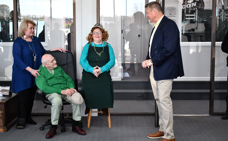The Rev. Billy Burrell (seated) listens to Pastor Mike Franklin (right) along with his daughter Joy (middle) and Kathy Osborne of WCON at a ceremony Tuesday to name a renovated studio after the longtime radio host. LANG STOREY/Staff