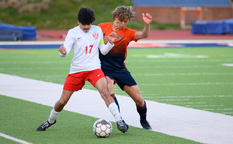 Owen Wallace battles a Gainesville player for possession near midfield in the home game Tuesday night. ZACH TAYLOR/Special