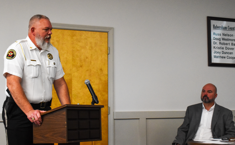 Sheriff Joey Terrell (left) talks passionately about  his chief deputy while Superintendent Matthew Cooper listens with interest at Monday’s meeting. EMMA MARTI/Staff