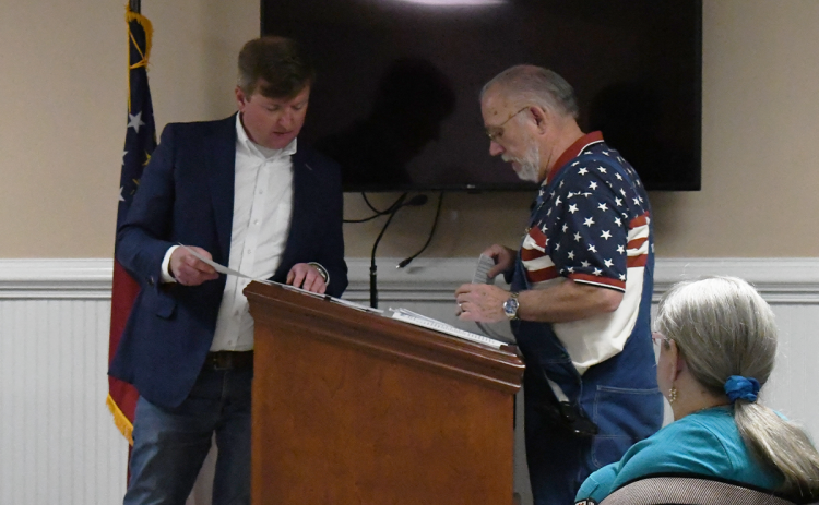 Demorest Mayor Jerry Harkness (left) consults with resident Mark Harris about the drawings for the city’s sewer bore project. MATTHEW OSBORNE/Staff