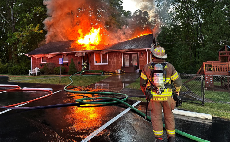 Habersham County Emergency Services Battalion Chief Michael Alexander monitors the effectiveness of the firefighting operations at the Hollywood Baptist Church pastorium Monday morning. HABERSHAM COUNTY/Submitted