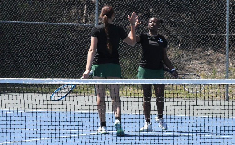 Tallulah Falls’ Katarina Foskey (left) and Azaria Junaid celebrate a point during their No. 1 doubles match on Monday. LANG STOREY/Staff