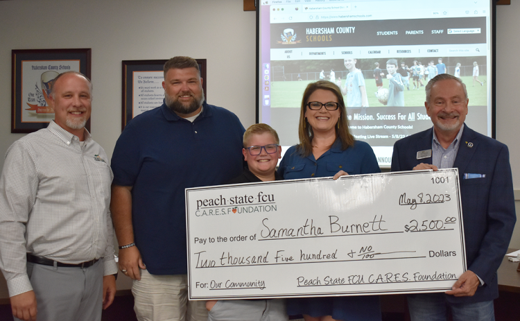 Samantha Burnett (second from right) received a Career Advancement Scholarship from Peach State Credit Union. Shown at the presentation are (from left) Scott Roland from Peach State, Thomas Burnett, Bryce Burnett, Samantha Burnett and John Fair. EMMA MARTI/Staff 