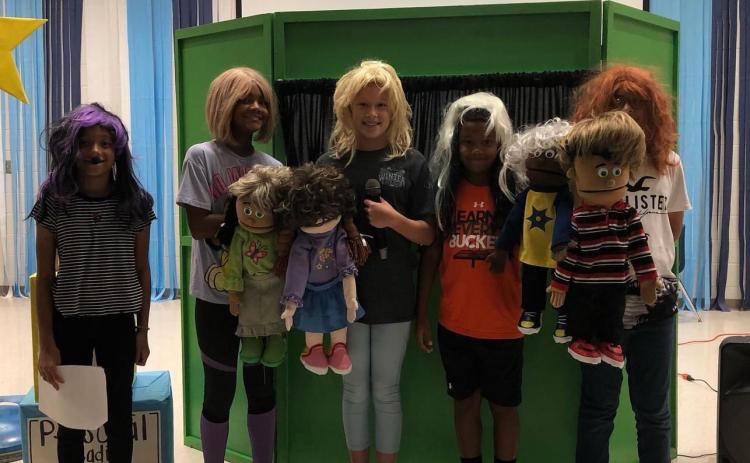 Cornelia Elementary students  London Garcia, Tinsley King, Ali Hartrick, Ty King and Steve Hernandez Mora pose with their puppets as part of a Leader in Me project. SUBMITTED