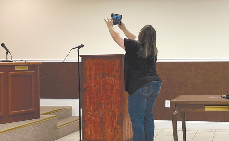Mayor Alice Venter shows the Facebook livestream viewers the lack of participants in Friday’s meeting focused on the public hearing of the fiscal year 2024 budget. JOHN DILLS/Staff
