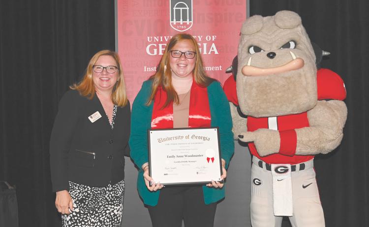 Emily Woodmaster (center) is recognized as a Certified Public Manager by the University of Georgia’s Carl Vinson Institute of Government. Woodmaster is the Chief Administrative Officer and City Clerk for the City of Baldwin. Pictured left to right are Marci Campbell and Hairy Dawg.