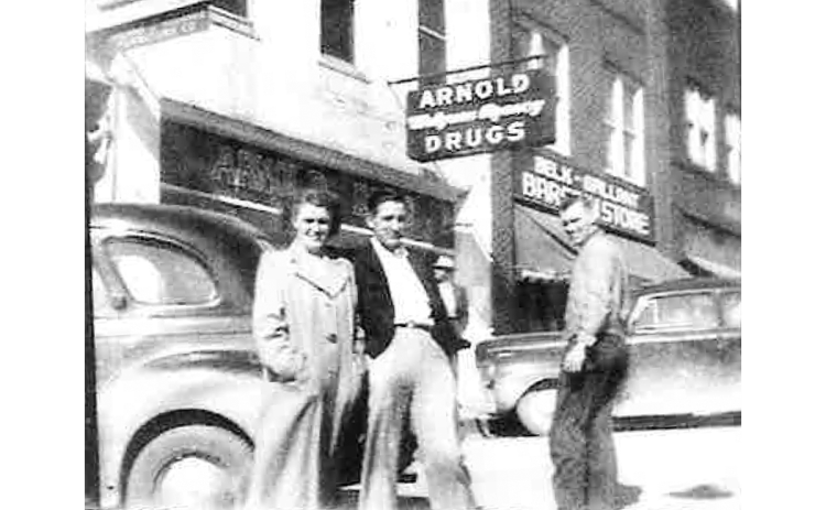 Willard Garrison, Mary Ruth Garrison Hosea and Herbert Hosea stand in front of what was previously Arnold Drug Store in downtown Cornelia, 1949. Photo reprinted from HABERSHAM 200