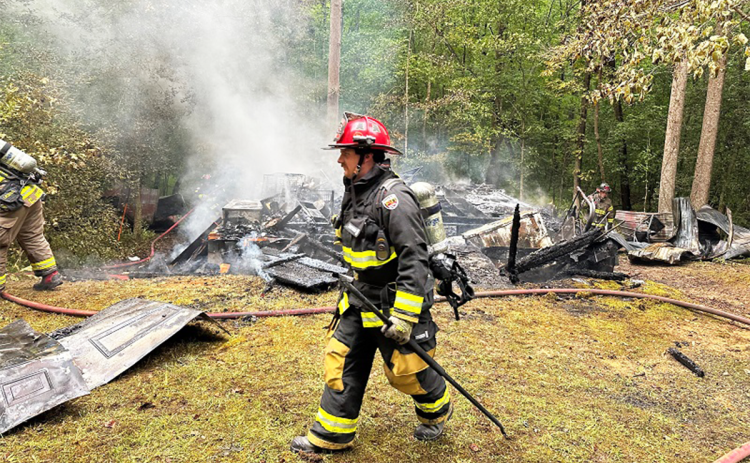 Firefighters move toward the incident commander at the scene of Monday’s fire on Hosanna Lane outside Cornelia. HABERSHAM COUNTY/Submitted
