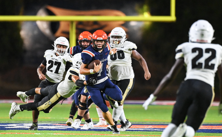 Habersham Central three-year varsity starting quarterback Carson Parker takes the first steps of his senior year, escaping tacklers during the Raiders’ exhibition win over East Hall on Friday. TOM ASKEW/Special