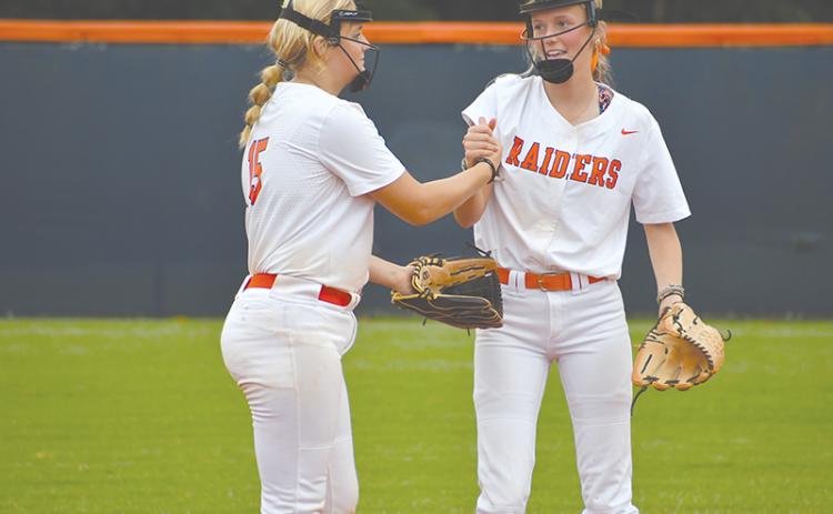 Habersham Central’s Hailee Parham (left) and Karsen Wade pump each other up before the inning begins. LANG STOREY/Staff