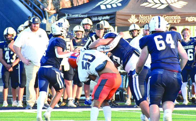 Habersham Central’s Alex Ethridge (50) gets “held” up on his way to White County quarterback Tripp Nix during last Friday’s game in Cleveland. Nix threw a touchdown on this play.  MATTHEW OSBORNE/Staff