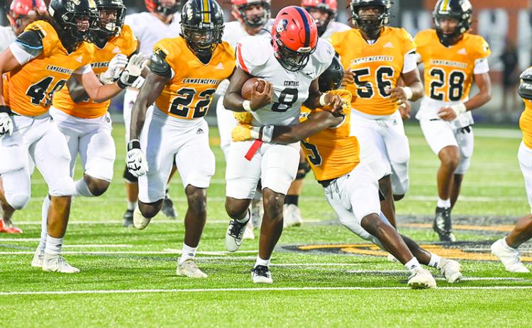 Habersham Central’s Antonio Cantrell drags a Central Gwinnett tackler last Friday night. TOM ASKEW/Special