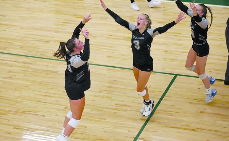 Tallulah Falls’ Addy McCoy, Claire Kelly and Chesney Tanksley celebrate a point during a recent home match. AUSTIN POFFENBERGER/Special