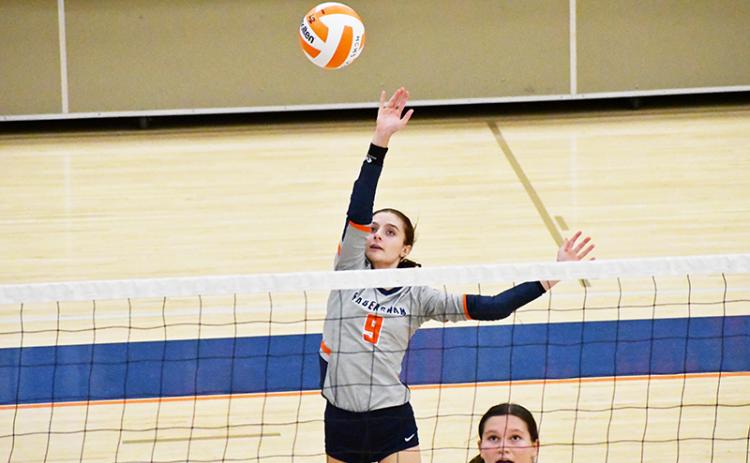 Habersham Central’s Maci Williams gets up high to play the ball during a recent home match. LANG STOREY/Staff