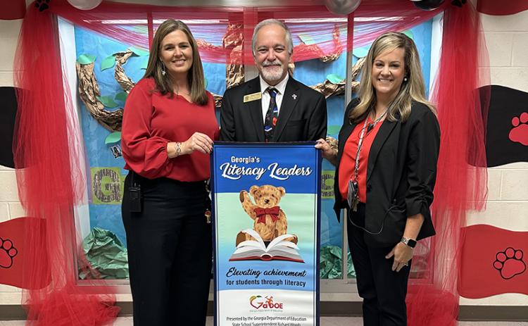 Level Grove Elementary School Principal Aimee Shedd (left), Georgia School Superintendent Richard Woods (center), and Level Grove Assistant Principal Stefanie Eaton (right), celebrate the school’s recognition as a “Literacy Leader.” SUBMITTED